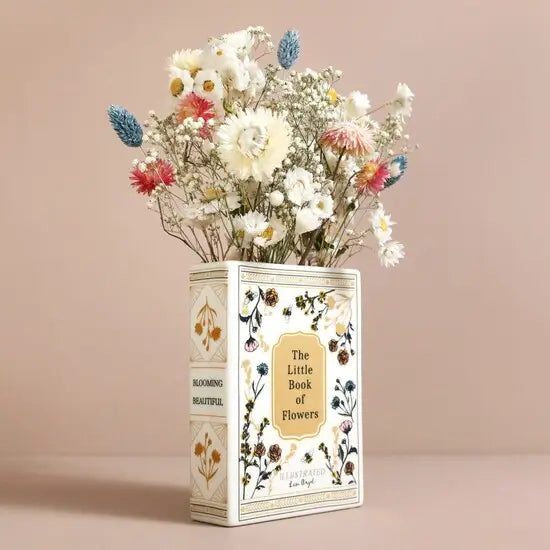 Book-shaped vase with flowers on a beige background